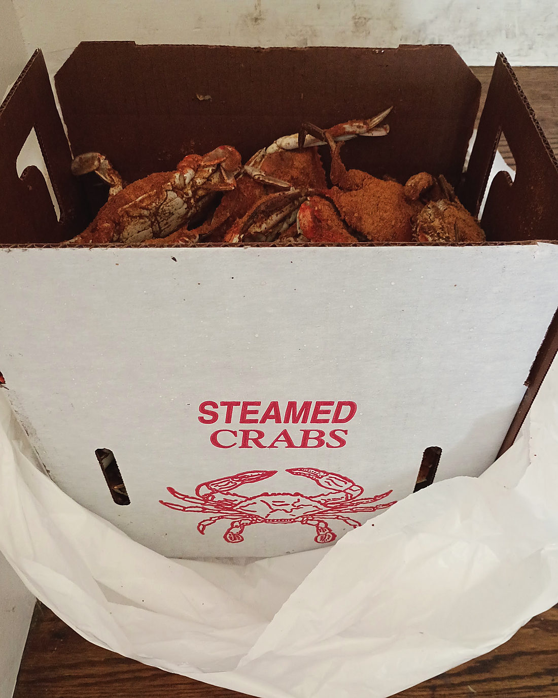 A white carry-out box printed Steamed Crabs